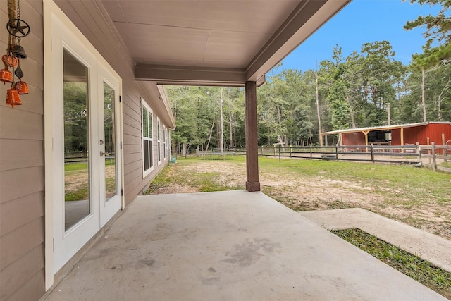 4142 Longhorn Dr, Cleveland, TX 77328 - view of patio / terrace with an exterior structure, view of wooded area, and an outbuilding