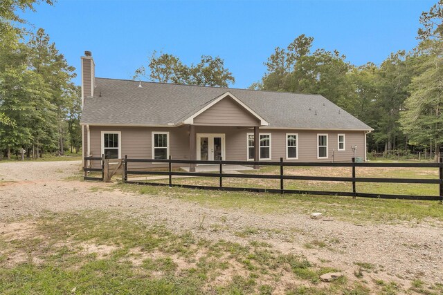 4142 Longhorn Dr, Cleveland, TX 77328 - back of property featuring french doors, a chimney, and roof with shingles