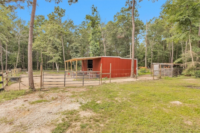 4142 Longhorn Dr, Cleveland, TX 77328 - view of yard with a pole building, an outbuilding, an exterior structure, and a wooded view