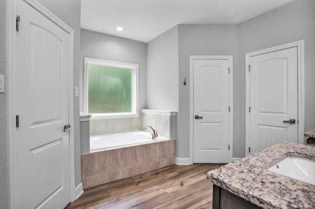 4142 Longhorn Dr, Cleveland, TX 77328 - full bathroom with vanity, a bath, wood finished floors, and recessed lighting