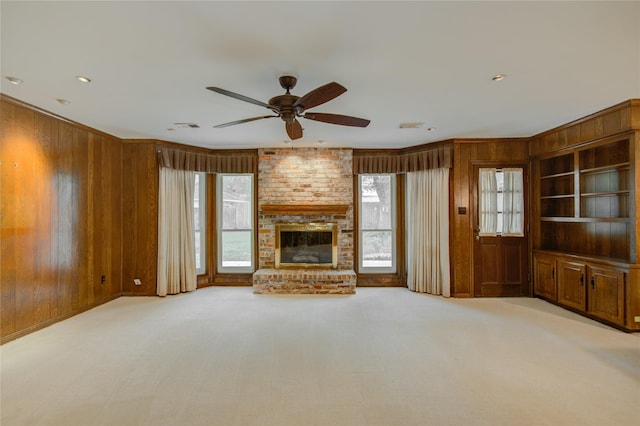 5311 Graystone Ln, Houston, TX 77069 - unfurnished living room with wooden walls, ceiling fan, a fireplace, crown molding, and carpet flooring