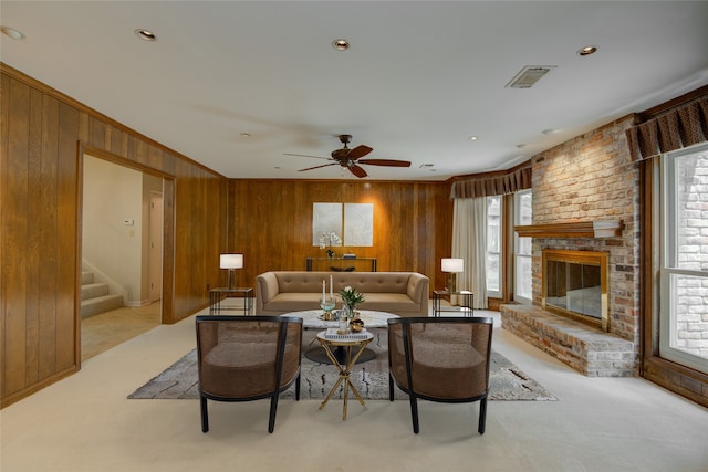 5311 Graystone Ln, Houston, TX 77069 - carpeted living room with wooden walls, healthy amount of natural light, stairway, ceiling fan, and crown molding