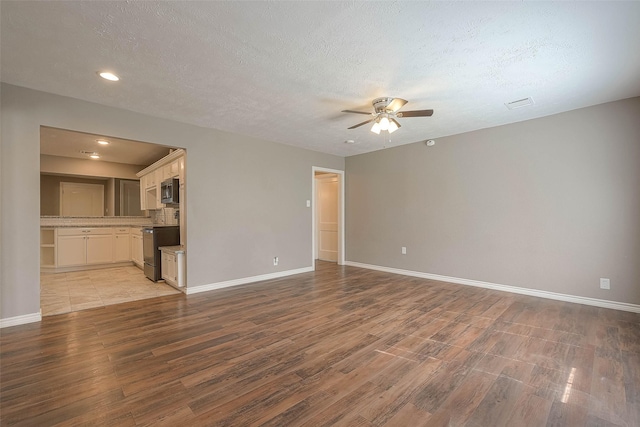 3915 Florinda St, Houston, TX 77021 - unfurnished living room with ceiling fan, light wood-style flooring, baseboards, recessed lighting, and a textured ceiling