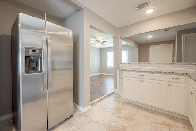 3915 Florinda St, Houston, TX 77021 - kitchen with stainless steel refrigerator with ice dispenser, baseboards, a ceiling fan, and light stone counters