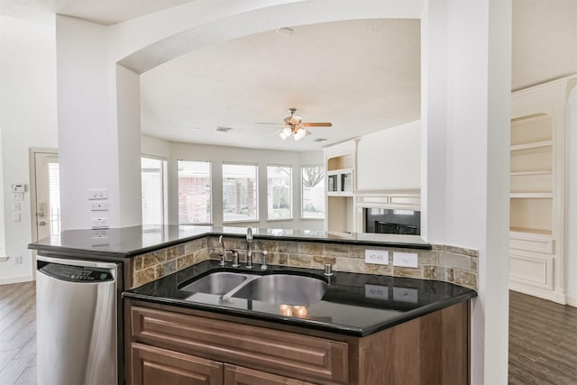 22011 Twinkle Sky Ct, Cypress, TX 77433 - kitchen featuring stainless steel dishwasher, a sink, dark countertops, and wood finished floors