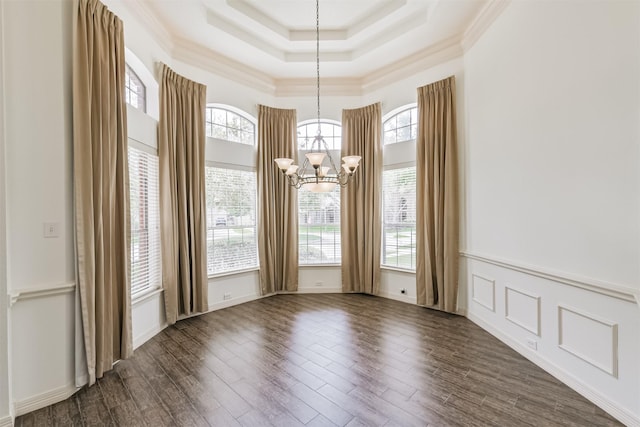 22011 Twinkle Sky Ct, Cypress, TX 77433 - unfurnished dining area with a chandelier, ornamental molding, a high ceiling, a tray ceiling, and dark wood-style flooring