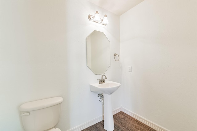 22011 Twinkle Sky Ct, Cypress, TX 77433 - half bathroom featuring toilet, wood finished floors, and baseboards