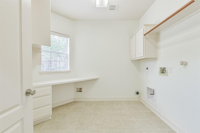 22011 Twinkle Sky Ct, Cypress, TX 77433 - laundry area featuring gas dryer hookup, electric dryer hookup, washer hookup, cabinet space, and light tile patterned floors