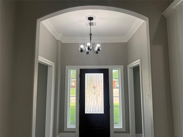 2407 Juliet St, Pasadena, TX 77502 - foyer featuring crown molding, arched walkways, and a chandelier