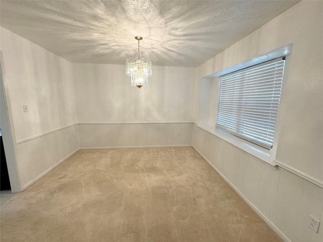 28811 Enchanted Dr, Shenandoah, TX 77381 - empty room featuring a chandelier, light colored carpet, and a textured ceiling