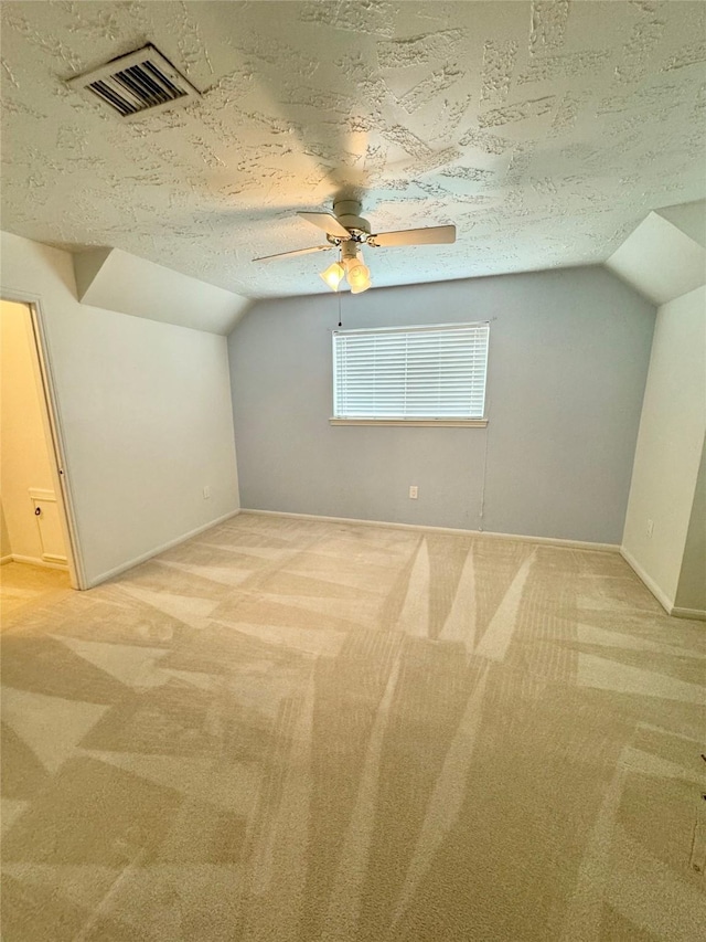 28811 Enchanted Dr, Shenandoah, TX 77381 - additional living space with lofted ceiling, light colored carpet, a textured ceiling, a ceiling fan, and baseboards