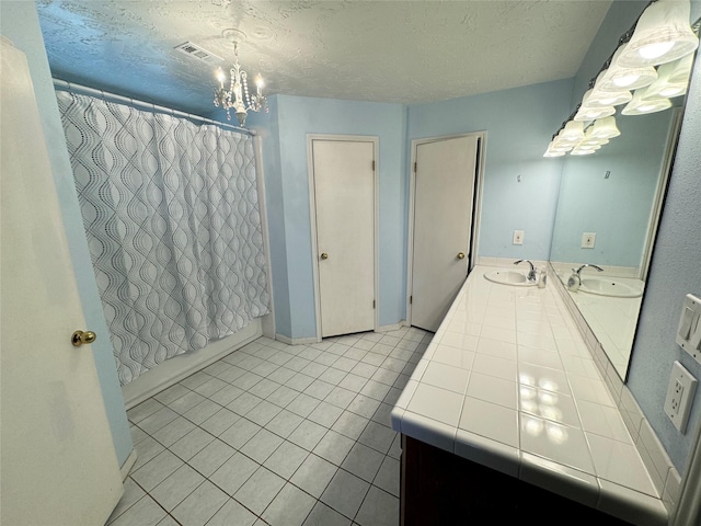 28811 Enchanted Dr, Shenandoah, TX 77381 - bathroom featuring tile patterned flooring, double vanity, a chandelier, a textured ceiling, and shower / bathtub combination with curtain