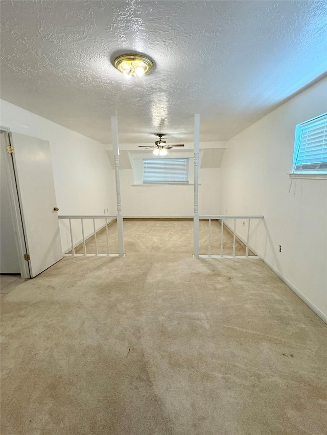28811 Enchanted Dr, Shenandoah, TX 77381 - below grade area featuring carpet floors, a textured ceiling, a ceiling fan, and baseboards