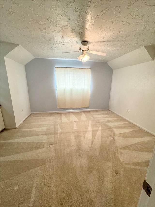 28811 Enchanted Dr, Shenandoah, TX 77381 - bonus room featuring lofted ceiling, light carpet, a textured ceiling, a ceiling fan, and baseboards