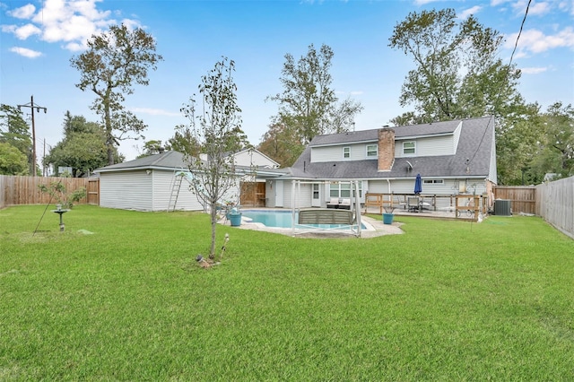 28811 Enchanted Dr, Shenandoah, TX 77381 - rear view of house with central air condition unit, a chimney, and a patio area