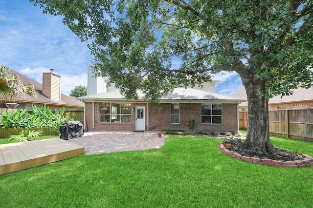 7115 Blanco Pines Dr, Humble, TX 77346 - back of house with brick siding, a patio, a deck, and a chimney