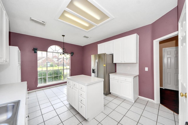 7115 Blanco Pines Dr, Humble, TX 77346 - kitchen with stainless steel fridge with ice dispenser, light countertops, white cabinetry, and a kitchen island