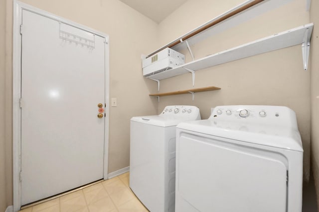 7115 Blanco Pines Dr, Humble, TX 77346 - laundry room featuring independent washer and dryer, light tile patterned floors, and baseboards