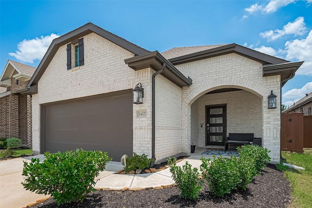 24227 Tallgrass Meadow Trl, Katy, TX 77493 - view of front facade featuring brick siding, a porch, and concrete driveway