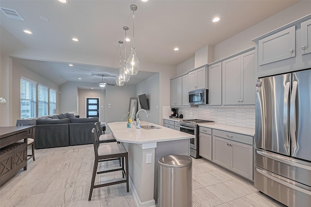 24227 Tallgrass Meadow Trl, Katy, TX 77493 - kitchen featuring stainless steel appliances, gray cabinets, backsplash, ceiling fan, and recessed lighting