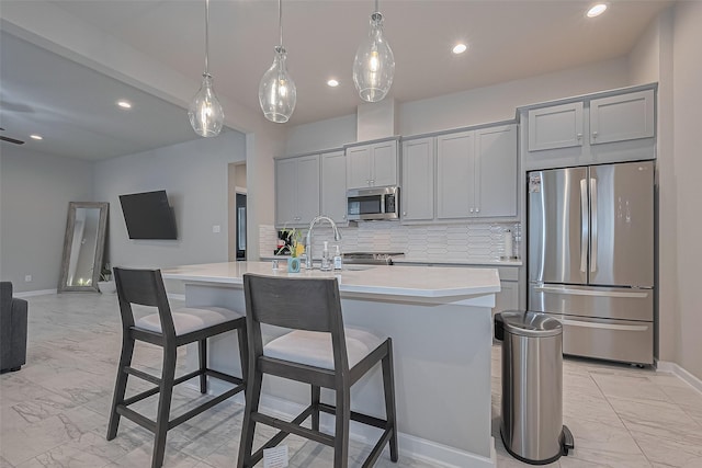 24227 Tallgrass Meadow Trl, Katy, TX 77493 - kitchen with stainless steel appliances, light marble finish floors, light countertops, gray cabinetry, and tasteful backsplash