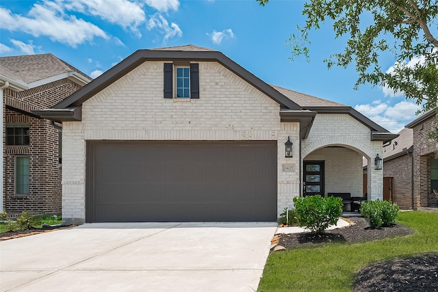 24227 Tallgrass Meadow Trl, Katy, TX 77493 - french country style house with brick siding, an attached garage, and concrete driveway