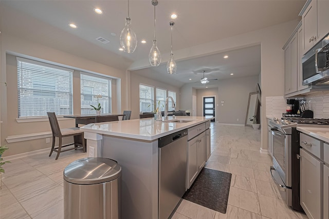 24227 Tallgrass Meadow Trl, Katy, TX 77493 - kitchen with a sink, stainless steel appliances, gray cabinets, recessed lighting, and decorative backsplash
