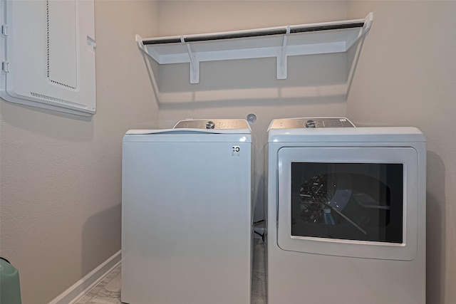 24227 Tallgrass Meadow Trl, Katy, TX 77493 - washroom with marble finish flooring, washing machine and clothes dryer, and baseboards