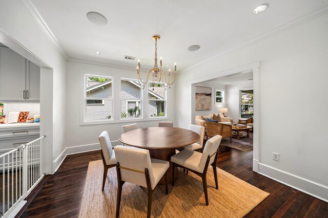 714 Merrill St, Houston, TX 77009 - dining room with a chandelier, crown molding, dark wood-style flooring, plenty of natural light, and baseboards