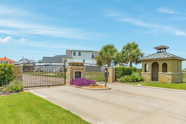 714 Vista Bella, Galveston, TX 77554 - view of concrete road featuring a gate, a gated entry, and curbs