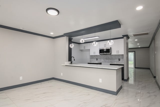 11835 S Ridgewood Cir, Houston, TX 77071 - kitchen with stainless steel microwave, a sink, baseboards, light marble finish flooring, and crown molding