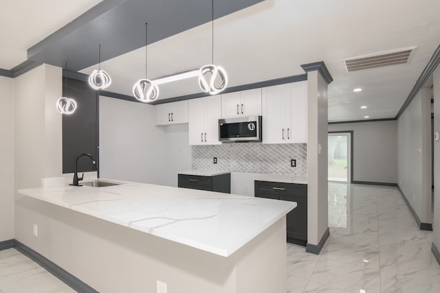 11835 S Ridgewood Cir, Houston, TX 77071 - kitchen with stainless steel microwave, light marble finish floors, light stone counters, baseboards, and recessed lighting