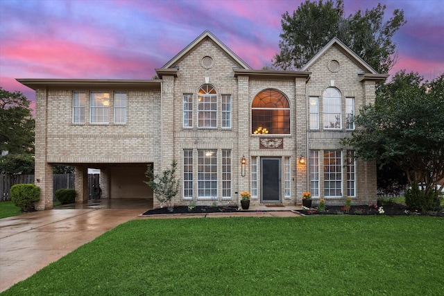16418 Willowpark Dr, Tomball, TX 77377 - view of front facade with a carport, brick siding, a front lawn, and concrete driveway