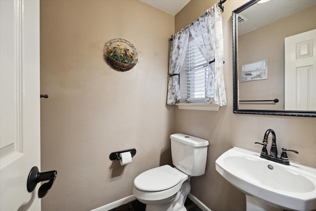 16418 Willowpark Dr, Tomball, TX 77377 - half bathroom with baseboards, toilet, and a sink