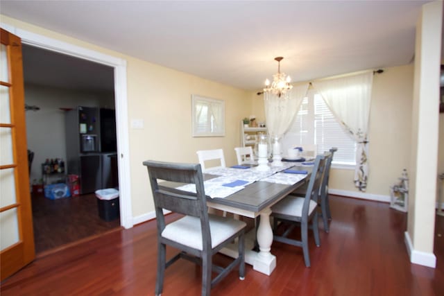 4604 Octavia St, Houston, TX 77026 - dining room featuring a chandelier, wood finished floors, and baseboards