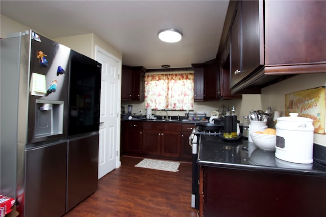 4604 Octavia St, Houston, TX 77026 - kitchen featuring stainless steel refrigerator with ice dispenser, dark countertops, dark wood finished floors, a sink, and dark brown cabinets