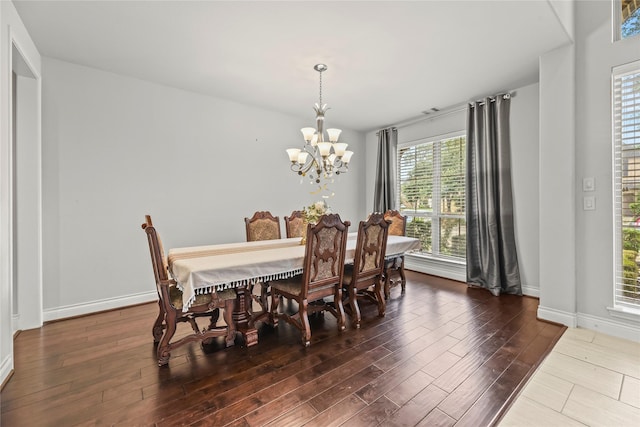 6 Volerran Path Ln, Missouri City, TX 77459 - dining room with wood finished floors, a chandelier, and baseboards