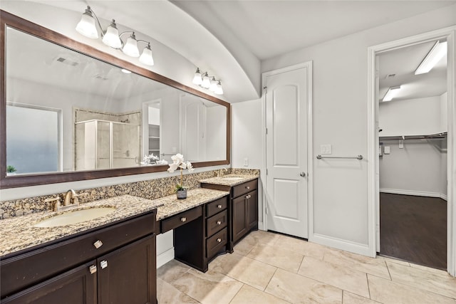6 Volerran Path Ln, Missouri City, TX 77459 - full bath with a stall shower, double vanity, a walk in closet, baseboards, and tile patterned floors