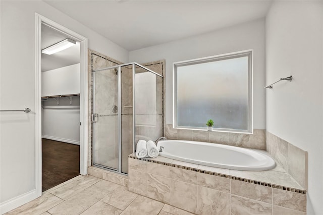 6 Volerran Path Ln, Missouri City, TX 77459 - bathroom featuring a bath, a shower stall, and a spacious closet