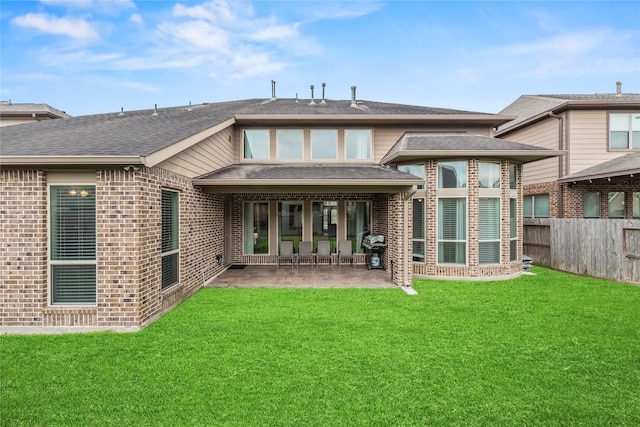 6 Volerran Path Ln, Missouri City, TX 77459 - rear view of house with a patio, brick siding, and a shingled roof