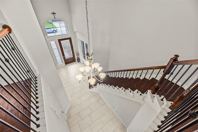 6 Volerran Path Ln, Missouri City, TX 77459 - foyer entrance with a chandelier, a towering ceiling, stairway, and tile patterned flooring