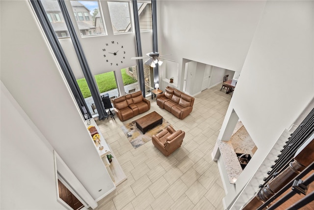 6 Volerran Path Ln, Missouri City, TX 77459 - living room with a high ceiling, ceiling fan, tile patterned floors, and baseboards