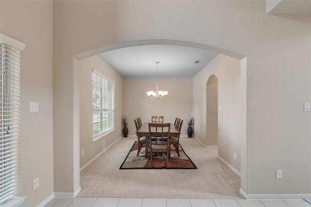 3610 Harewood Ct, Pearland, TX 77584 - dining space with arched walkways, light carpet, a chandelier, and baseboards