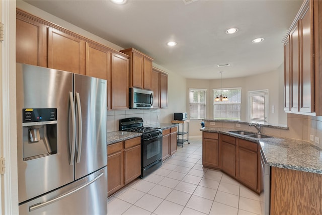3610 Harewood Ct, Pearland, TX 77584 - kitchen with stainless steel appliances, a sink, brown cabinetry, backsplash, and recessed lighting