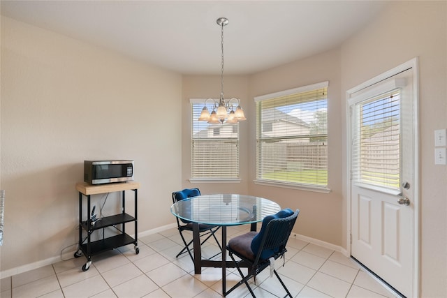 3610 Harewood Ct, Pearland, TX 77584 - dining room with a chandelier, baseboards, and light tile patterned floors