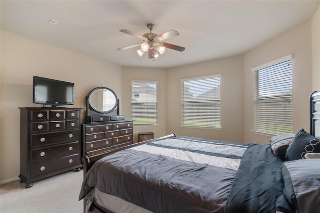 3610 Harewood Ct, Pearland, TX 77584 - bedroom with light colored carpet, multiple windows, a ceiling fan, and baseboards