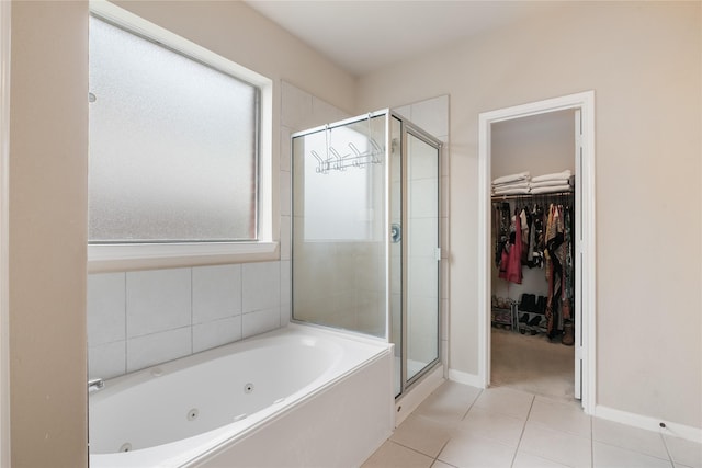 3610 Harewood Ct, Pearland, TX 77584 - full bathroom featuring a stall shower, a whirlpool tub, tile patterned flooring, a walk in closet, and baseboards