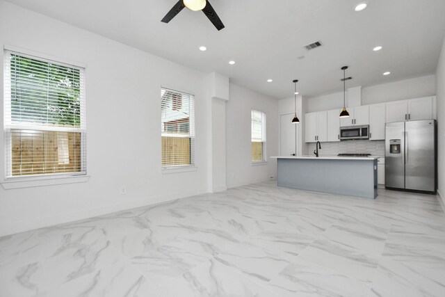 849 Mansfield St Unit F, Houston, TX 77091 - kitchen with stainless steel appliances, ceiling fan, recessed lighting, plenty of natural light, and decorative light fixtures