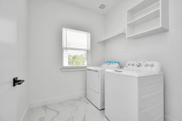 849 Mansfield St Unit F, Houston, TX 77091 - laundry area featuring independent washer and dryer and light marble finish floors
