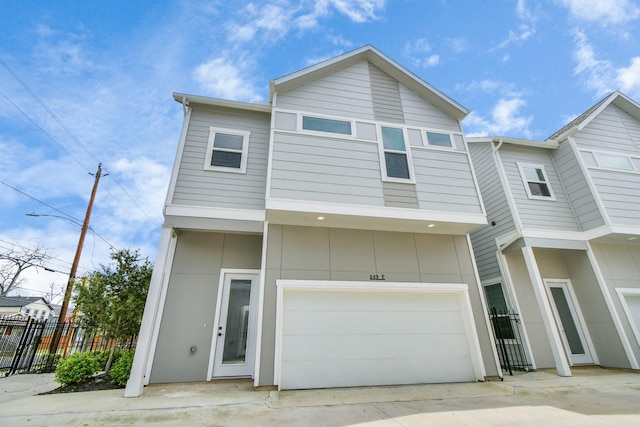 849 Mansfield St Unit F, Houston, TX 77091 - view of front of house with a garage and concrete driveway